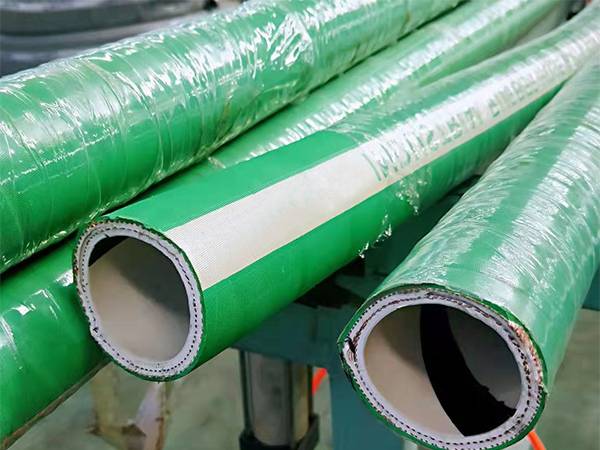 A picture that can see four green chemical rubber hoses.