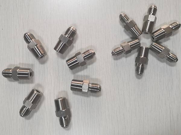 13 JIC hydraulic adaptors arranged in two flower shapes.