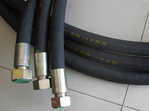 Three pieces o f SAE 100R9 hydraulic  hoses with fittings on one side.