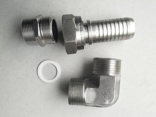 Hex pipe nipple, straight female fitting and male 90° elbow fitting on table